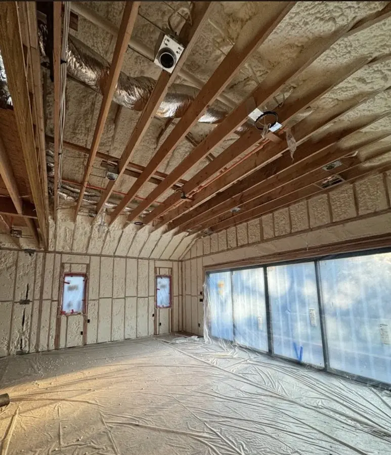 Interior walls and ceiling insulated with spray foam during new construction in Asheville